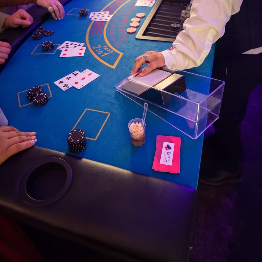 Dealt hands, chips and an Echo-branded card on the blue felt
