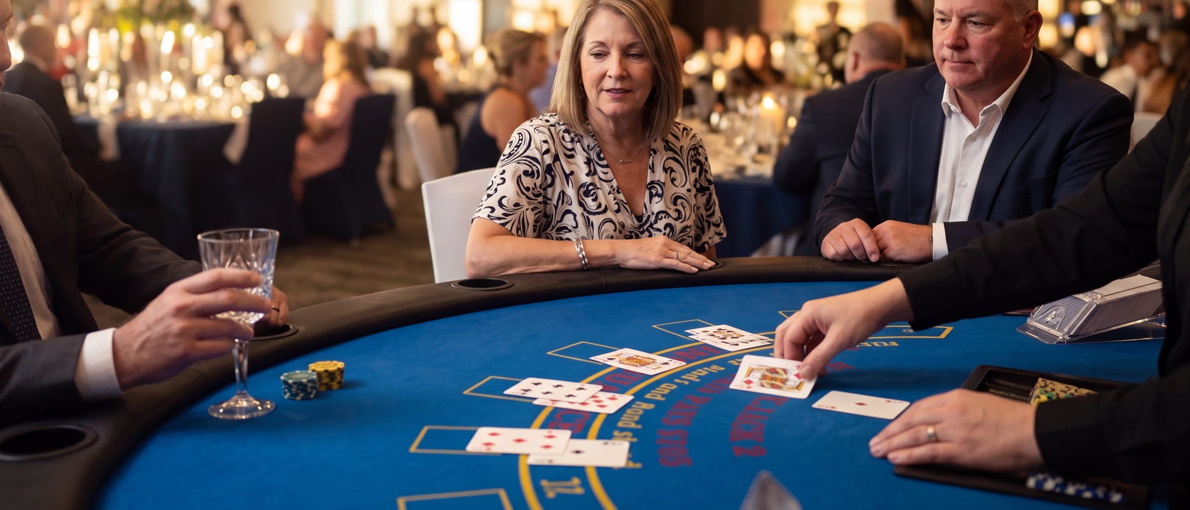 Cards being dealt on the felt at a gala reception blackjack table